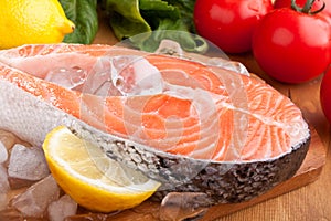 Salmon steak with lemon on ice