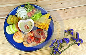 Salmon steak with side dishes in blue plate