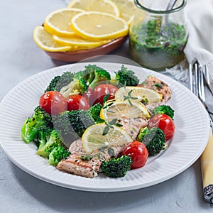 Salmon steak with vegetables, baked salmon fillet with broccoli and tomato on plate, square format