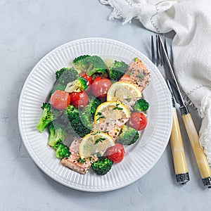 Salmon steak with vegetables, baked salmon fillet with broccoli and tomato, top view, square format