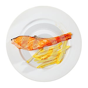 Salmon steak with vegetables side dish of fries