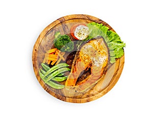 Salmon steak on wooden plate