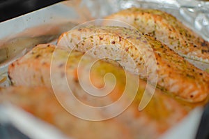 Salmon steaks oven roasted on a foil close up