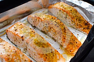 Salmon steaks oven roasted on a foil close up