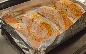 Salmon steaks oven roasted on a foil close up