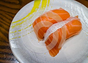 Salmon sushi or salmon nigiri in Japanese style fresh serve on white plate