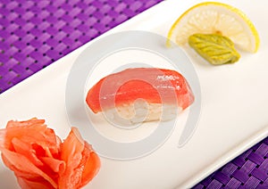 Salmon sushi on the plate, lemon, wasabi and ginger