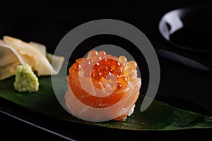 Salmon Sushi roll with caviar topping Japanese food