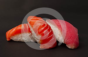 Salmon sushi and tuna sushi on black background