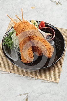 Salmon tempura sticks is deep fried salmon mixing with tempura flour served with sweet sauce.