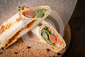 Salmon tortilla on baking paper with peppercorns