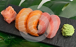 Salmon tuna nigiri sushi set on green palm leaf