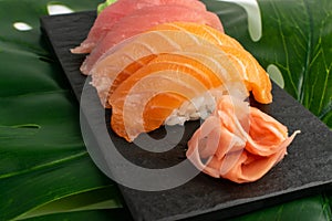 Salmon tuna nigiri sushi set on green palm leaf