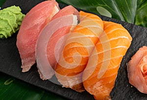 Salmon tuna nigiri sushi set on green palm leaf