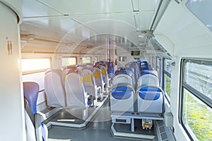 Salon inside of the speed commuter train with empty seats.