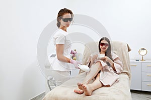 In salon setting, woman experiences efficient laser removal of leg hair