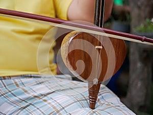 Salor, two or three-string spike fiddle used in the Lanna region or in the North of Thailand, being played