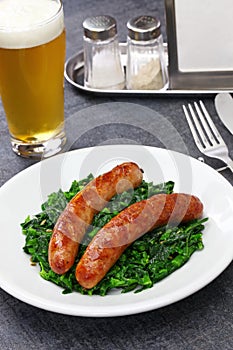 Salsiccia e cime di rapa, sausage and braised tunip greens photo