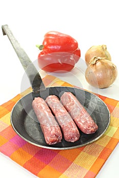 Salsiccia with vegetales in a pan photo