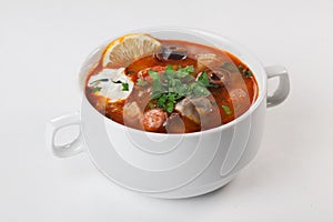 Salsola with sausages and mushrooms in a bowl with pens white background