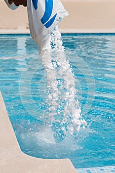 Salt being added to a brine swimming pool