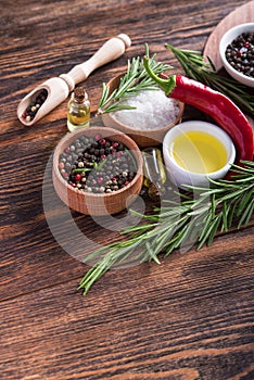 Salt, black seed pepper, branch of rosemary, red hot chili