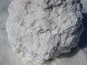 Salt block, a huge block of salt on which structured grains of salt are visible