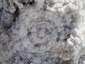 Salt block, a huge block of salt on which structured grains of salt are visible