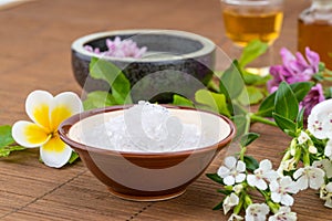 Salt bowl, essential oil, flower float on water china backgroun