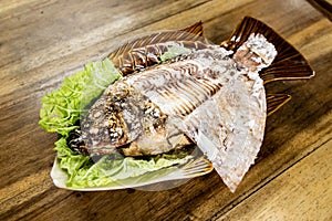 Salt crusted barbecue fish is popular street food in Thailand.