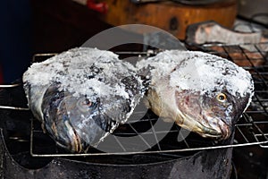 Salt crusted barbecue fish is popular street food in Thailand. The fish is masked with salt and ready to be be grilled