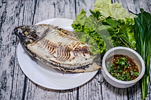 Salt-Crusted Grilled Fish eaten with seafood sauce.