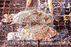 Salt Crusted Grilled Nile Tilapia Fish on Grate