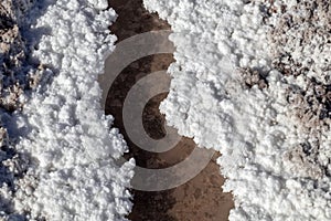 Salt crystals on the salty surface of desert close up. Natural background with copy space