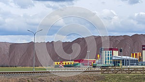 Salt dump. Wagons with potash fertilizers are being prepared for shipment. Freight car behind barbed wire. Sanctions.