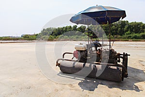 Salt farmers with car roller.