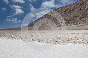 Salt flats lined by mountains at Badwater Basin in Death Valley National Park, California