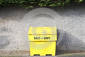 Salt grit yellow container for winter road safety on council road uk