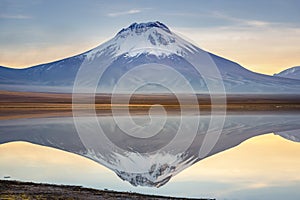 Salt lake Lejia reflection, idyllic volcanic landscape at Sunset, Atacama, Chile photo