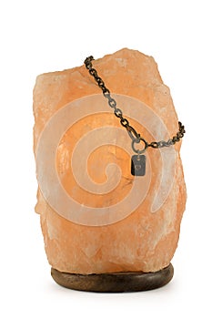 Salt lamp with chain and heart isolated on white background