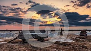 Salt mining on dry lake during sunset