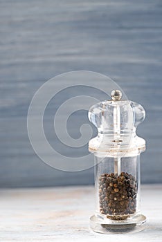 Salt and pepper grinders on a wooden background