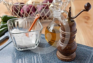 Salt, pepper mill, and olive oil