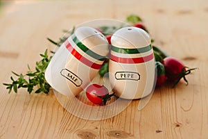 Salt and pepper shakers on a wooden table.