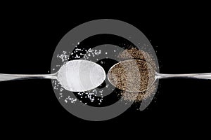 Salt and pepper on spoons