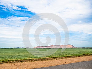 Salt piles among the green fields. salt lake mining of potassium salts in Belarus. salt mining and production