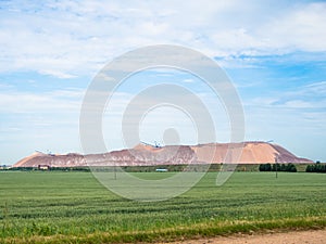 Salt piles among the green fields. salt lake mining of potassium salts in Belarus. salt mining and production