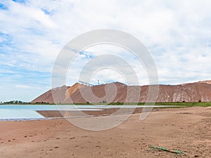 Salt piles among the green fields. salt lake mining of potassium salts in Belarus. salt mining and production