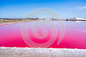 Salt production, pink lagoon and hills in the Mediterranean sea is located in Aigues-Mortes . Camargue, France
