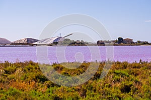 Salt production, pink lagoon and hills in the Mediterranean sea is located in Aigues-Mortes . Camargue, France. Hight